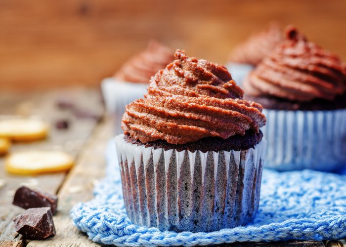 vegan gluten free cocoa cupcakes on a blue knitted cloth