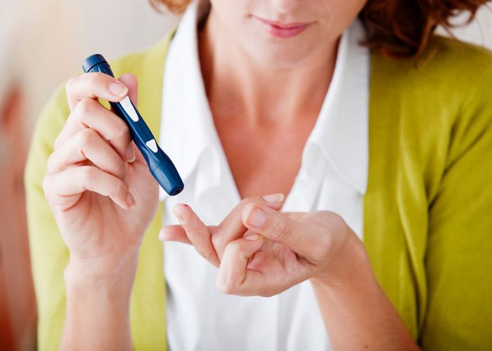 Woman doing skin prick insulin test for type-I diabetes autoimmune disease