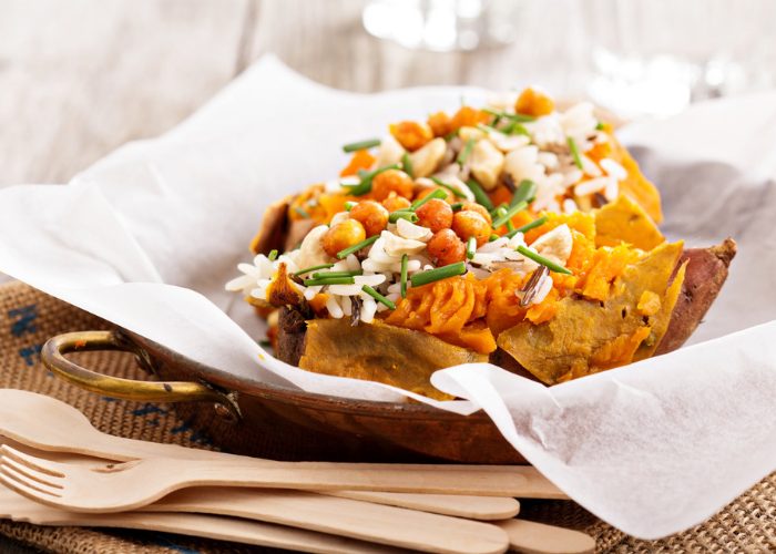 Plant-based meal of baked sweet potato topped with beans