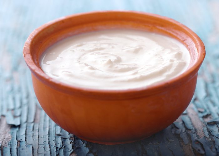 Homemade Greek yogurt in an orange clay bowl