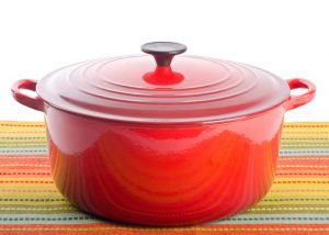 Red dutch oven on a colorful tablecloth
