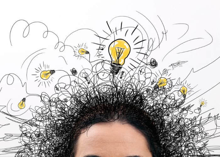 Woman's head with light bulbs and squiggles drawn above it to represent memory and thoughts