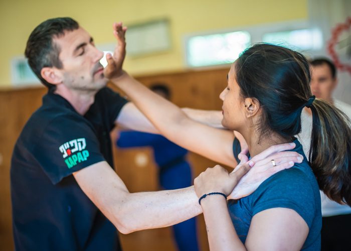 A woman practicing the Israeli martial arts, Krav Maga is a partner