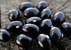 Close up of black beans on a wooden table