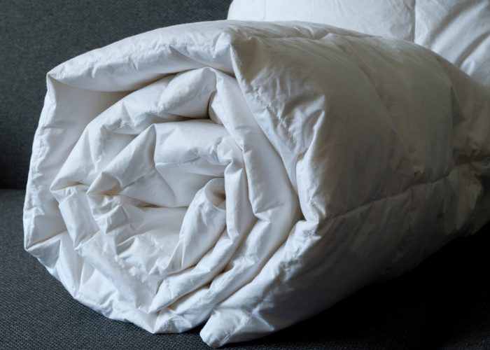 Rolled up white weighted blanket for adults