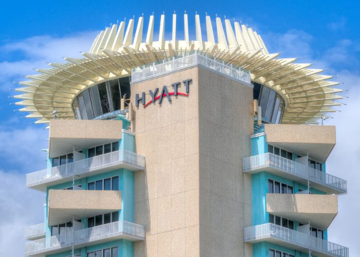 A sandstone colored Hyatt hotel block with light blue accents