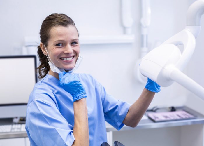 Female dental hygienist smiling at work