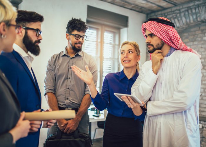 Female Arabic interpreter translating for a group of business men