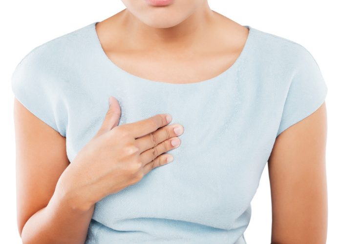 Woman suffering from acid reflux pain pressing on her chest