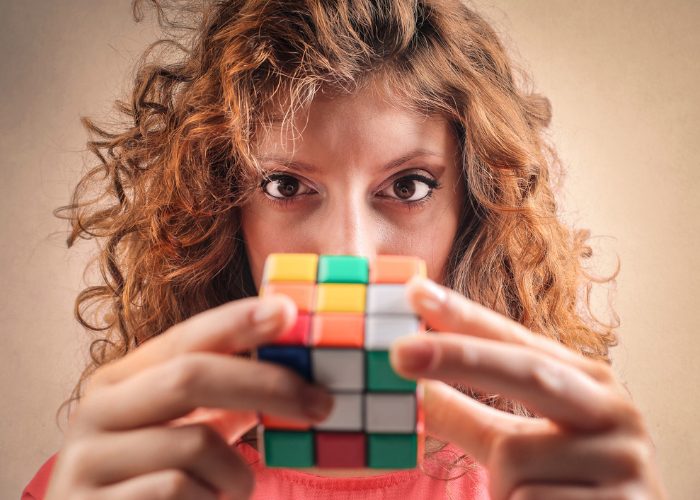 Woman solving a Rubik's cube for brain training