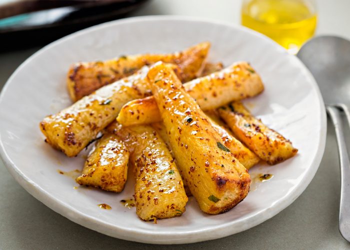 Homemade Honey Roasted Parsnips on a white plate