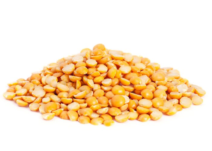 Yellow peas heaped on a white table