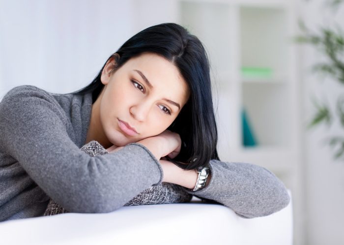 Woman with depression leaning on her hands  