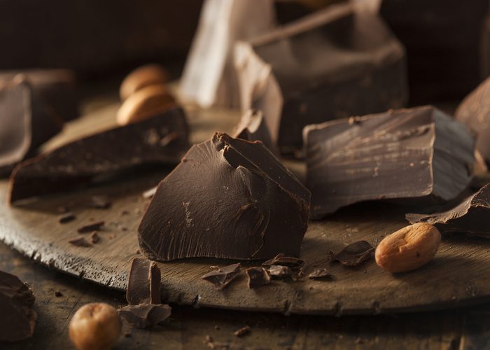 Chunks of dark chocolate on a wooden board