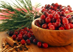 Dozens of cranberries piled high in small wooden bowls