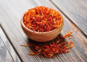 A bowl of saffron on a wooden table