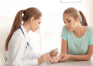 Woman getting her insulin shot at the doctors