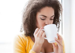 Woman drinking a cup of detox tea