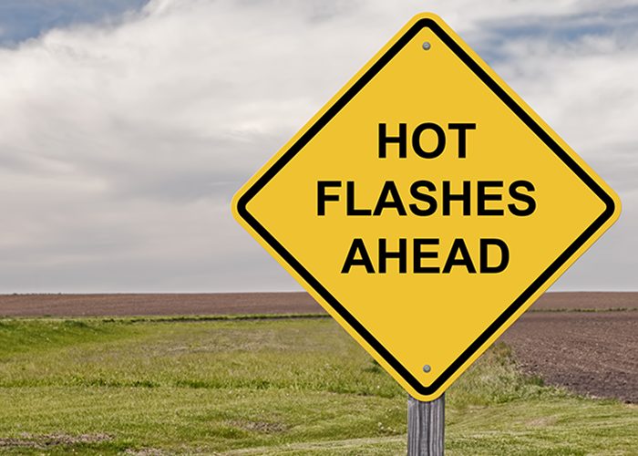 Signboard written with "hot flashes ahead"