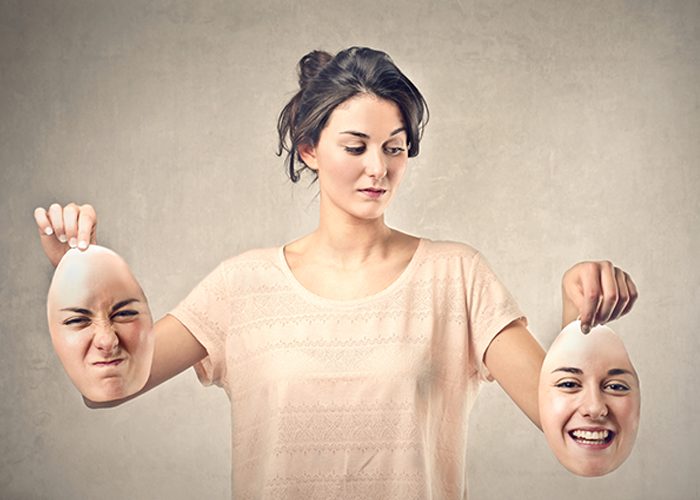 Woman with impostor syndrome holding two different masks