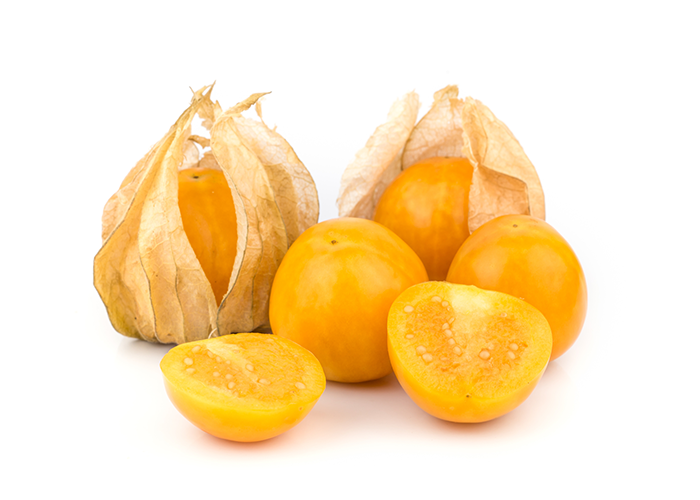 Close up of two golden berries in their husks, two open berries, and one halved golden berry on a white surface.