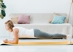 woman doing planks for a calisthenics workout at home