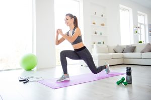 woman doing calisthenics workout in her home