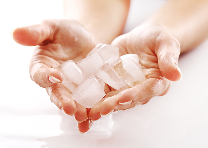 Woman holding a pile of ice in her hands