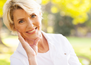 Mature woman smiling in the park. 