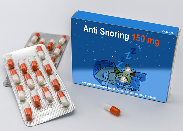 A blue box of anti snoring tablets with pill packets next to it.