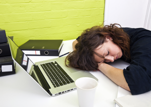 Woman asleep at her office desk.