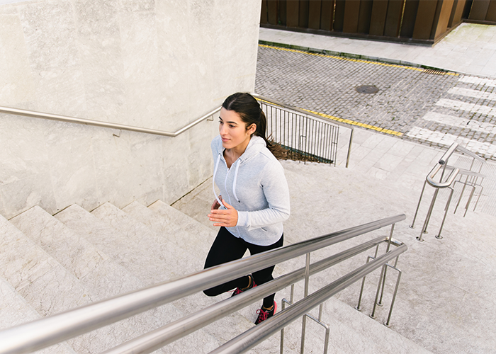 Woman running up stairs for HIIT exercise