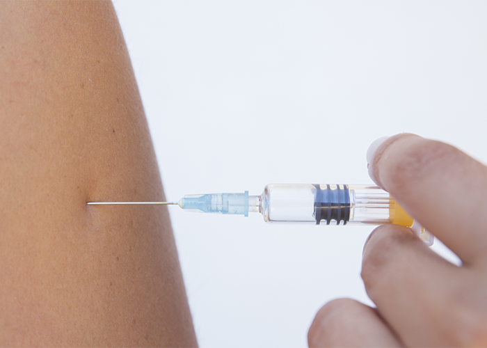 Close up of needle going into arm