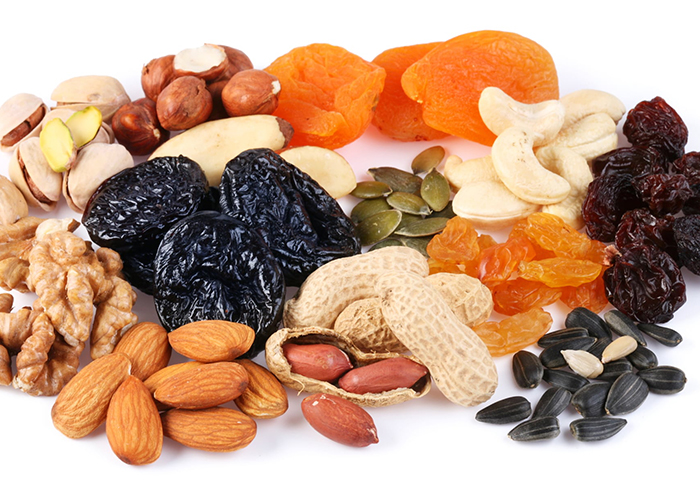 An assortment of dried fruits and nuts eaten as Paleo snacks for weight loss