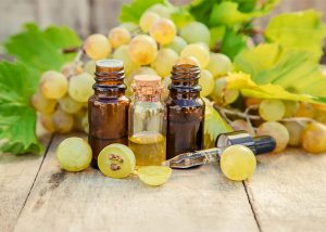 Bottles of grapeseed essential oil for skin anti-aging
