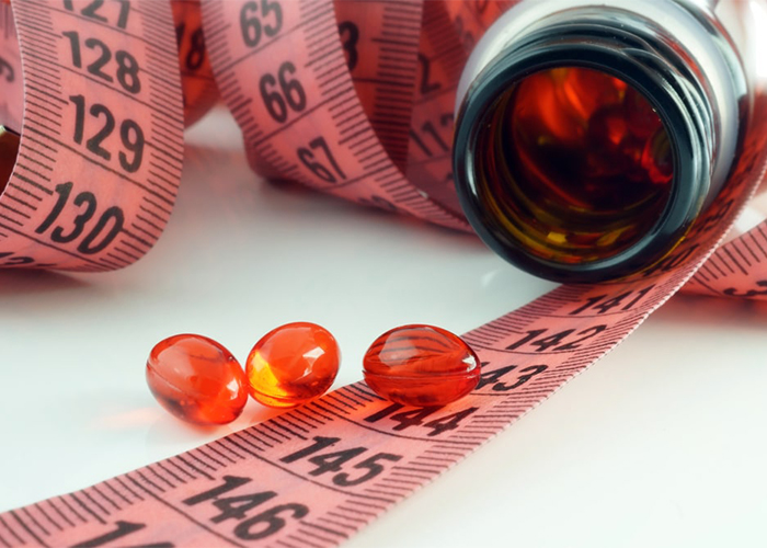 Keto weight loss pills for weight loss on a tape measure