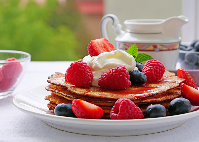 Stack of Paleo pancakes topped with berries