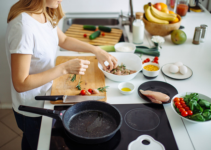 Woman cooking a paleo meal in her kitchen