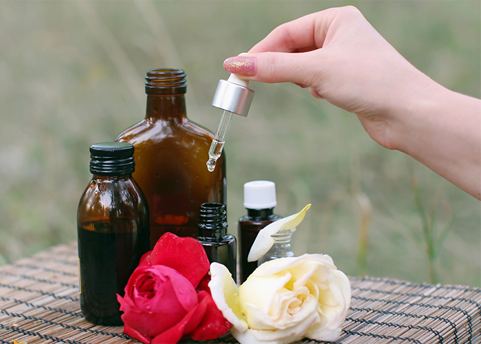Woman using many types of essential oils outside
