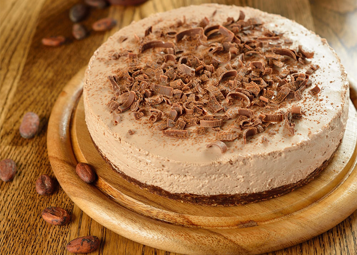 Whole cocoa Paleo cheesecake topped with dark chocolate shavings 