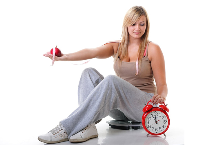 Woman looking at a clock wondering how long her Keto plateau will last