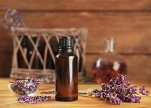 A bottle of lavender essential oil surrounded by dry lavender