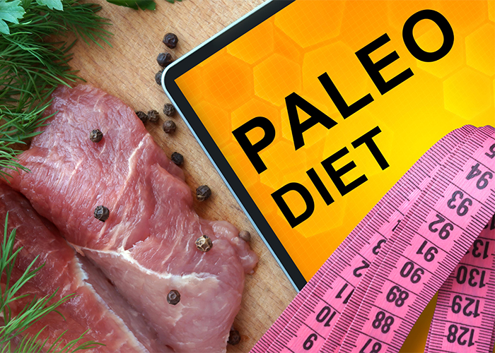 A "Paleo Diet" sign with a measuring tape, fresh meat, and herbs