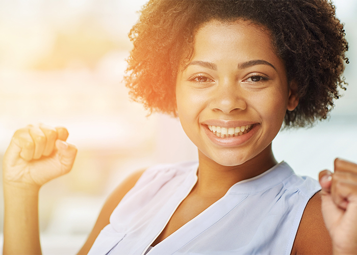 Woman smiling proudly due to her success on the AIP diet