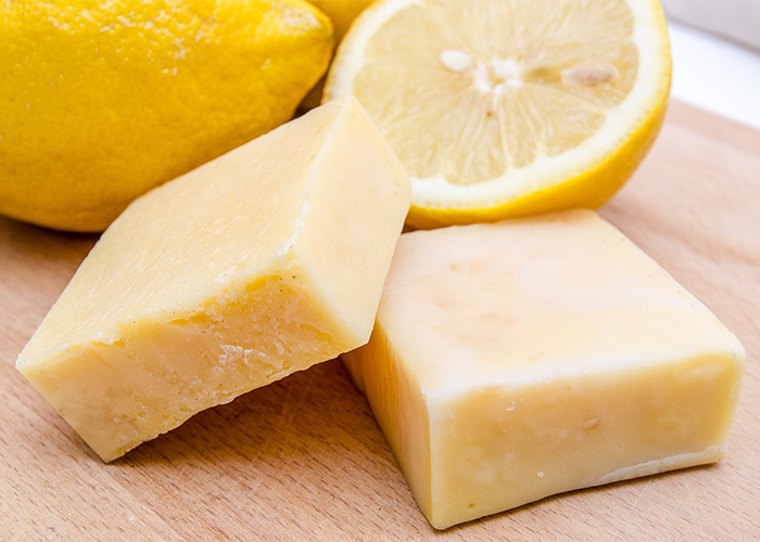Homemade antibacterial manuka soap on a wooden board with lemons