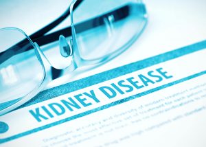 A pair of glasses on a document with the heading "KIDNEY DISEASE"